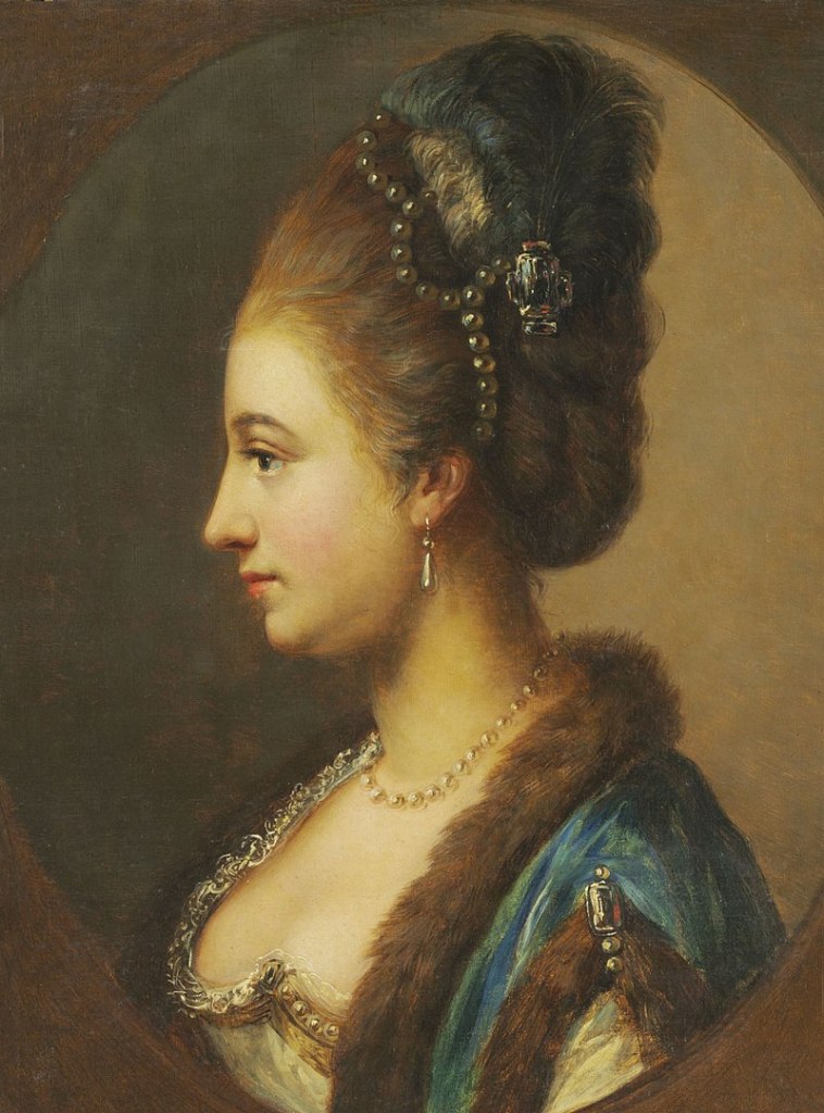 A side portrait of the head and shoulders of a white woman (Princess Philippine). She has her slightly powdered hair in an up do decorated with pearls. She is wearing a blue dress with fur trim. The neckline of the dress is decorated with jewels. She is wearing a necklace and earrings.